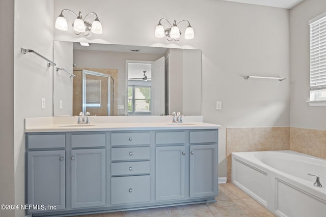 bathroom featuring plus walk in shower, dual vanity, tile patterned flooring, and ceiling fan