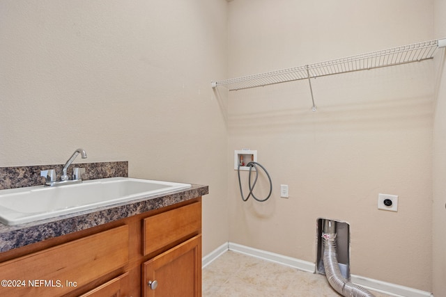 clothes washing area featuring hookup for a washing machine, sink, cabinets, hookup for an electric dryer, and light tile patterned flooring