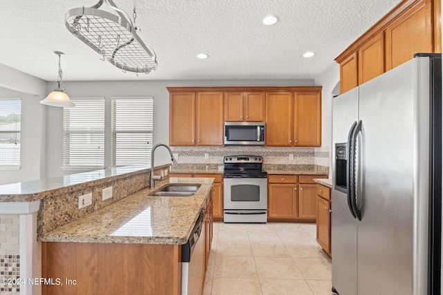 kitchen with stainless steel appliances, sink, hanging light fixtures, backsplash, and light tile patterned floors