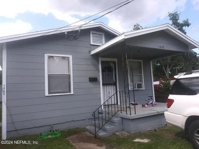 bungalow-style house featuring cooling unit