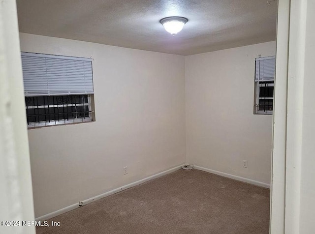 1479 8th St W, Jacksonville, FL 32209 - carpeted empty room with baseboards and a textured ceiling