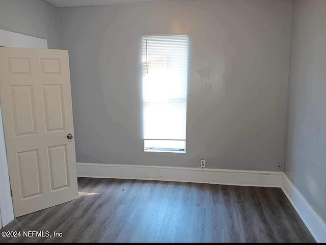 spare room featuring dark hardwood / wood-style floors