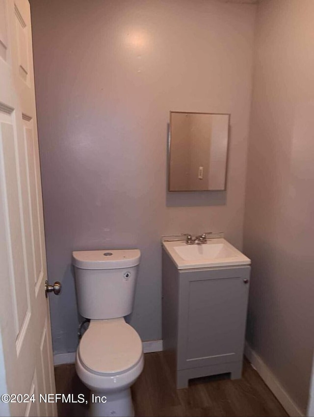 bathroom featuring hardwood / wood-style flooring, vanity, and toilet