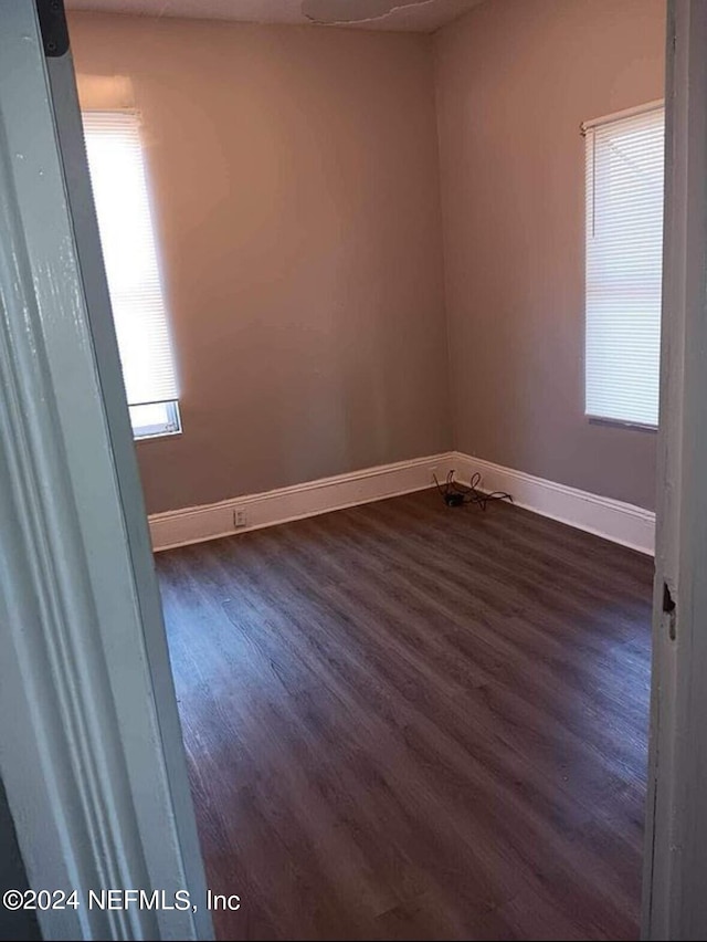 unfurnished room featuring dark hardwood / wood-style flooring