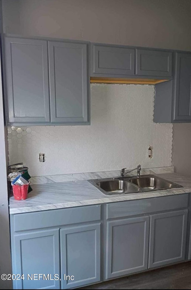 kitchen with gray cabinetry and sink