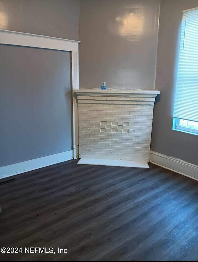 unfurnished living room with dark hardwood / wood-style floors