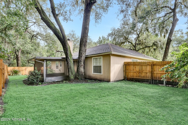 back of house with a yard