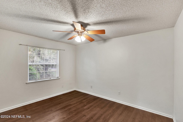 spare room with a textured ceiling, dark hardwood / wood-style floors, and ceiling fan