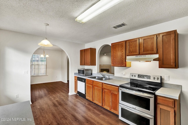 kitchen with a notable chandelier, dark hardwood / wood-style flooring, stainless steel appliances, and decorative light fixtures