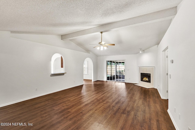 unfurnished living room with a textured ceiling, vaulted ceiling with beams, dark hardwood / wood-style floors, and ceiling fan