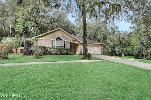 ranch-style house featuring a front yard and a garage