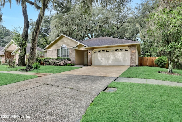 single story home featuring a garage and a front yard