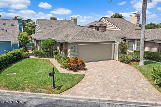 view of front facade with a garage and a front yard