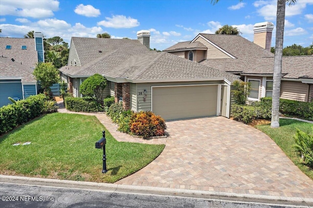 view of front facade with a garage and a front yard