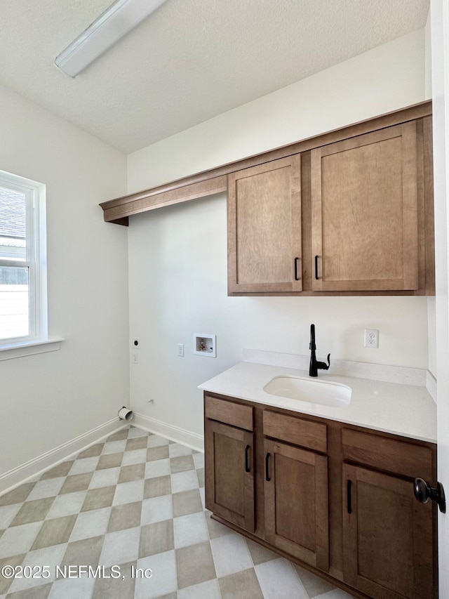 clothes washing area featuring sink, cabinets, washer hookup, a textured ceiling, and hookup for an electric dryer