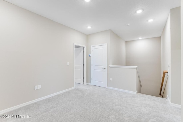 unfurnished room with light carpet