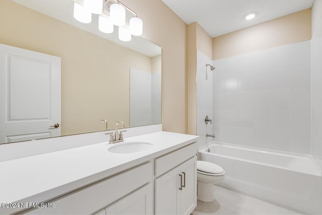 full bathroom with tiled shower / bath combo, vanity, and toilet