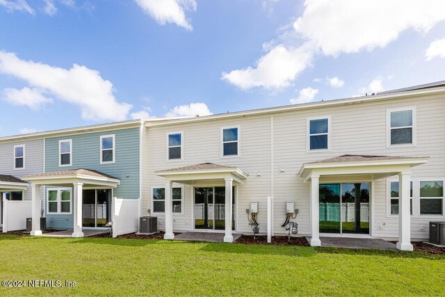 rear view of property featuring a yard, a patio area, and central air condition unit