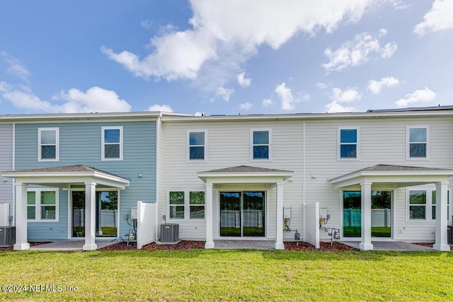 back of house with a patio, a yard, and central AC