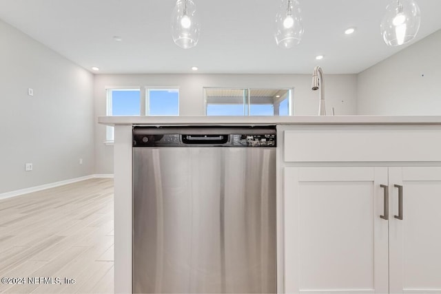 kitchen with sink, stainless steel dishwasher, white cabinets, and light wood-type flooring