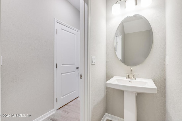 bathroom with hardwood / wood-style floors