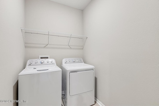 laundry room featuring washing machine and clothes dryer