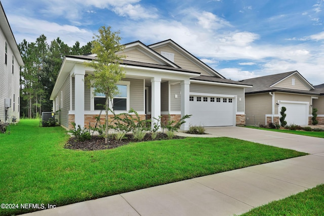 craftsman inspired home with a front yard, central AC, and a garage