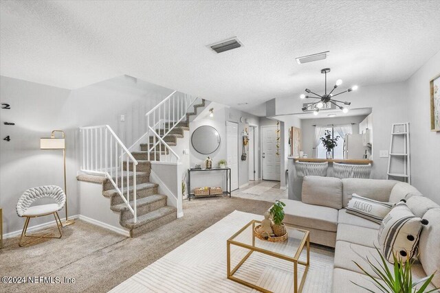 carpeted living room with an inviting chandelier and a textured ceiling