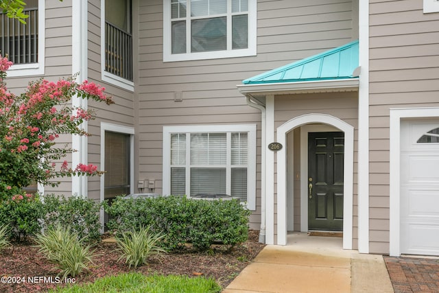 doorway to property featuring a garage