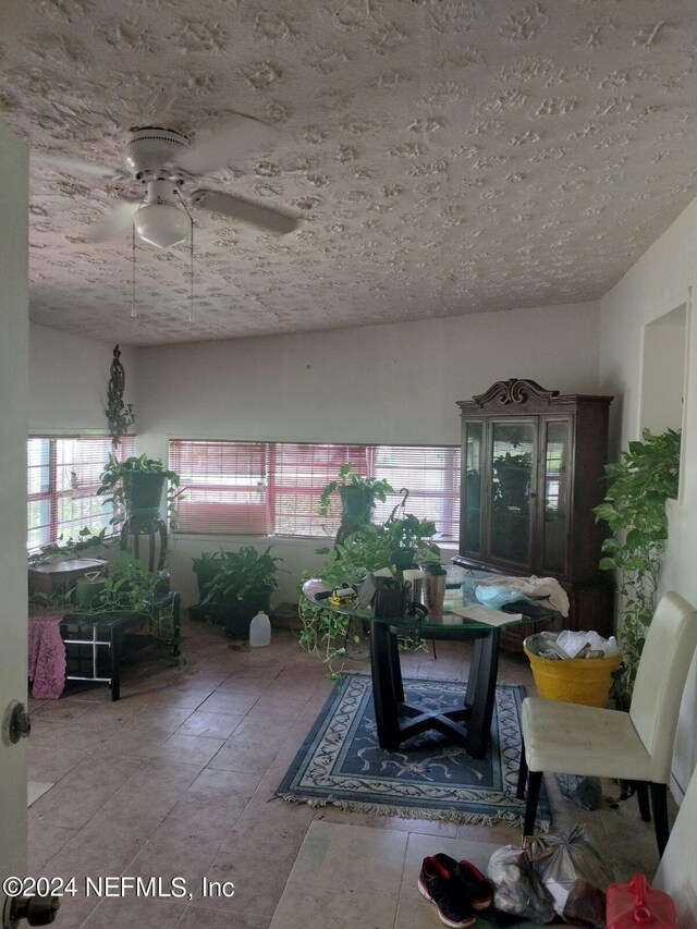 interior space with ceiling fan