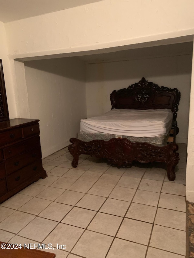 bedroom featuring light tile patterned floors