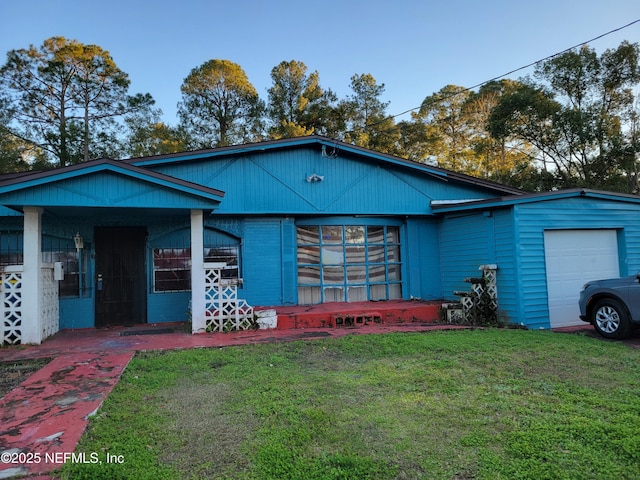 view of front of home with a garage and a front lawn