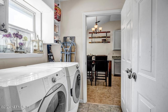 laundry room featuring light tile patterned flooring and washer and clothes dryer