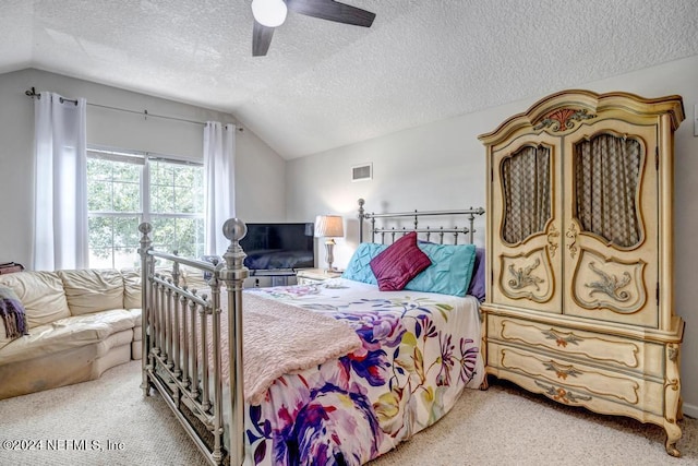 carpeted bedroom with lofted ceiling, ceiling fan, and a textured ceiling