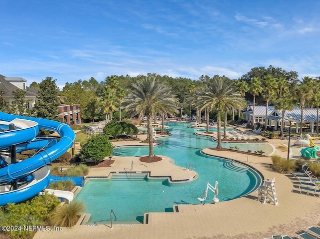 view of pool featuring a water slide and a patio area