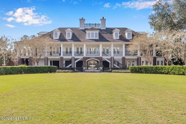 rear view of property with a yard