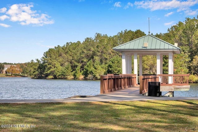 view of dock featuring a gazebo, a lawn, and a water view