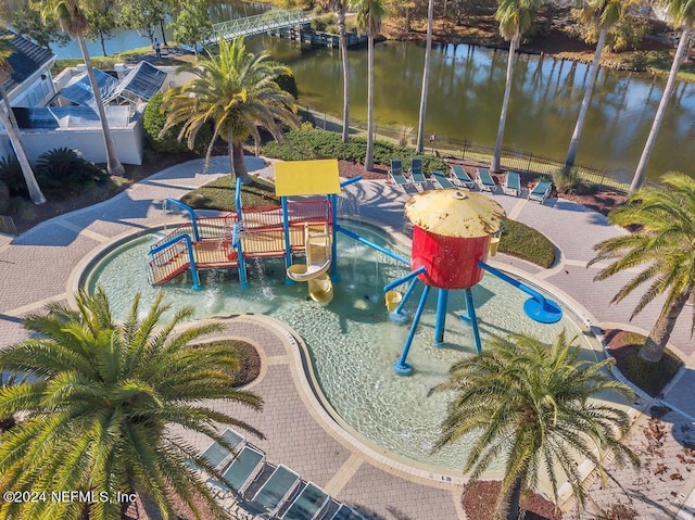 view of swimming pool featuring a playground and a water view