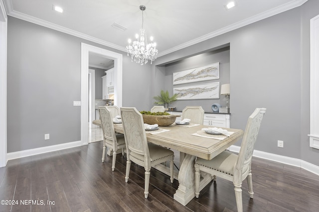 dining area featuring visible vents, baseboards, ornamental molding, dark wood finished floors, and an inviting chandelier