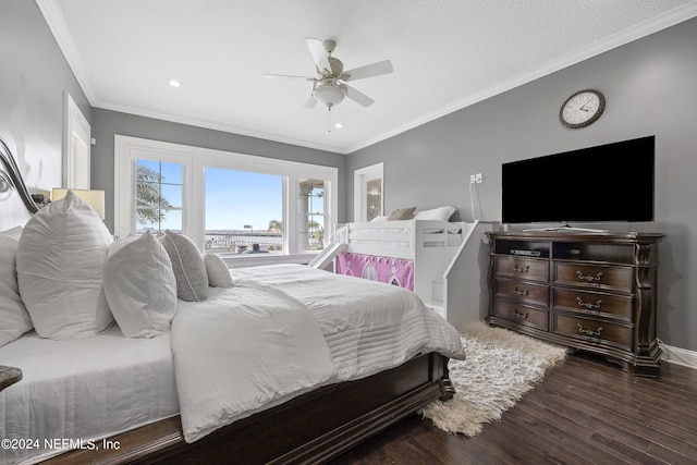 bedroom featuring baseboards, ceiling fan, wood finished floors, crown molding, and a textured ceiling