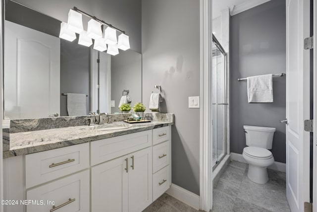 full bathroom featuring a shower stall, baseboards, vanity, and toilet