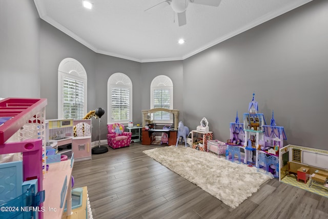 playroom featuring baseboards, crown molding, a ceiling fan, and wood finished floors