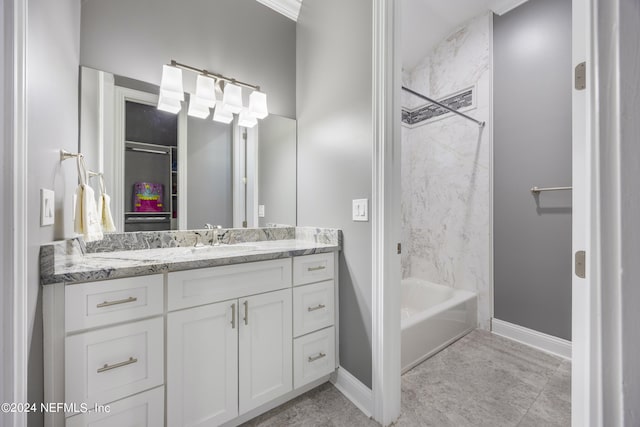 full bathroom featuring bathtub / shower combination, baseboards, and vanity