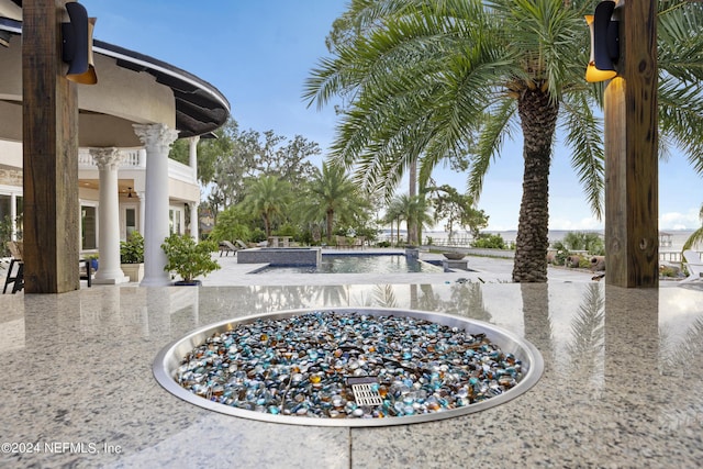 details with a swimming pool and ornate columns