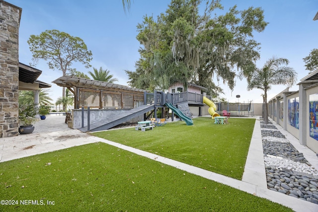 view of yard with fence and playground community