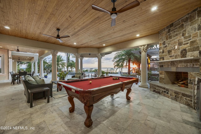 recreation room with wood ceiling, stone tile flooring, decorative columns, and recessed lighting