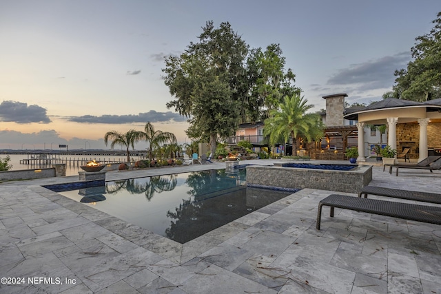 pool featuring an in ground hot tub, a patio area, and a gazebo