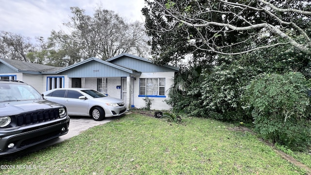 view of front of house with brick siding and a front yard