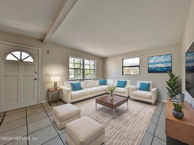 living room with lofted ceiling with beams and light tile patterned floors