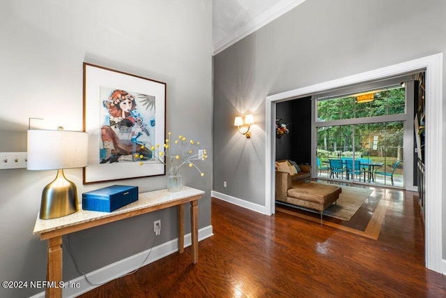 interior space with ornamental molding and dark hardwood / wood-style flooring